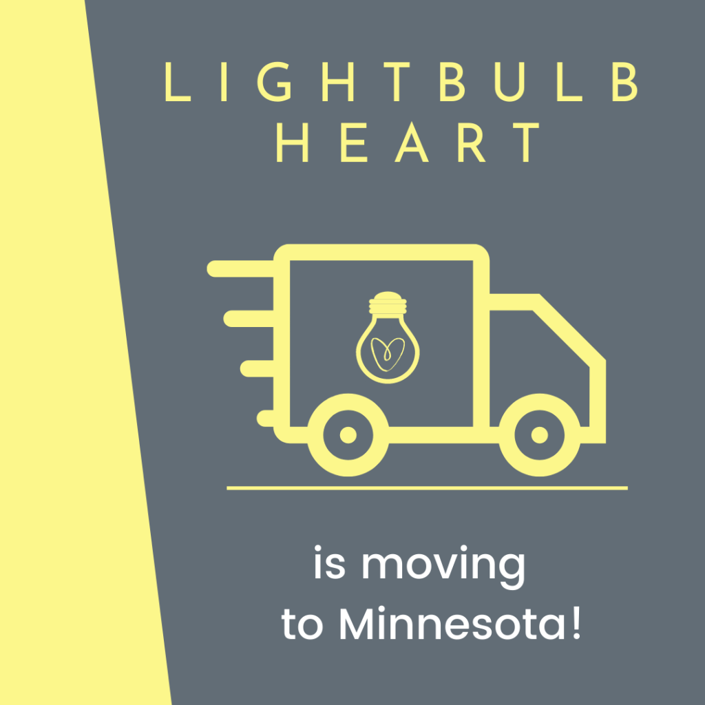 A yellow moving truck with the Lightbulb Heart logo on its side moves from left to right on a grey background. Text reads: "Lightbulb Heart is moving to Minnesota!"